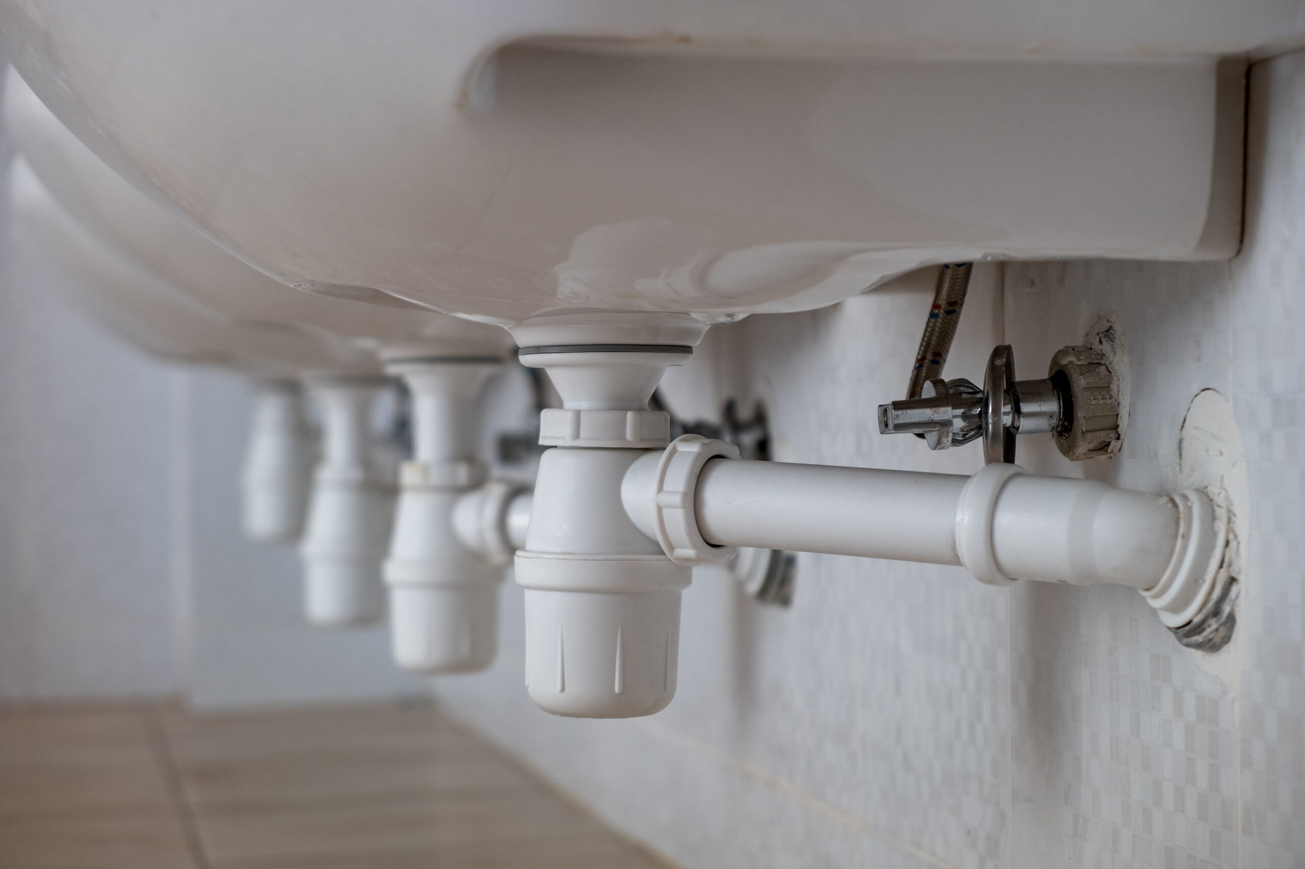 Close,Up,Of,White,Plastic,Pipe,Drain,Under,Washing,Sink